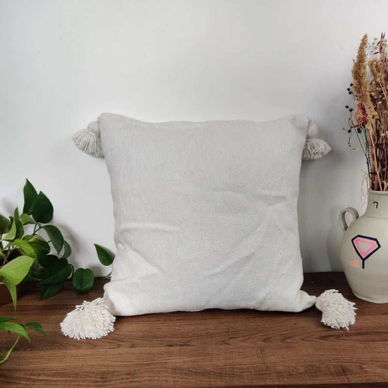 coussin à pompons blanc