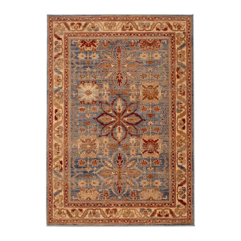 Tapis oriental en laine beige, bleu et rouge par, avec motifs floraux et bordures décoratives.