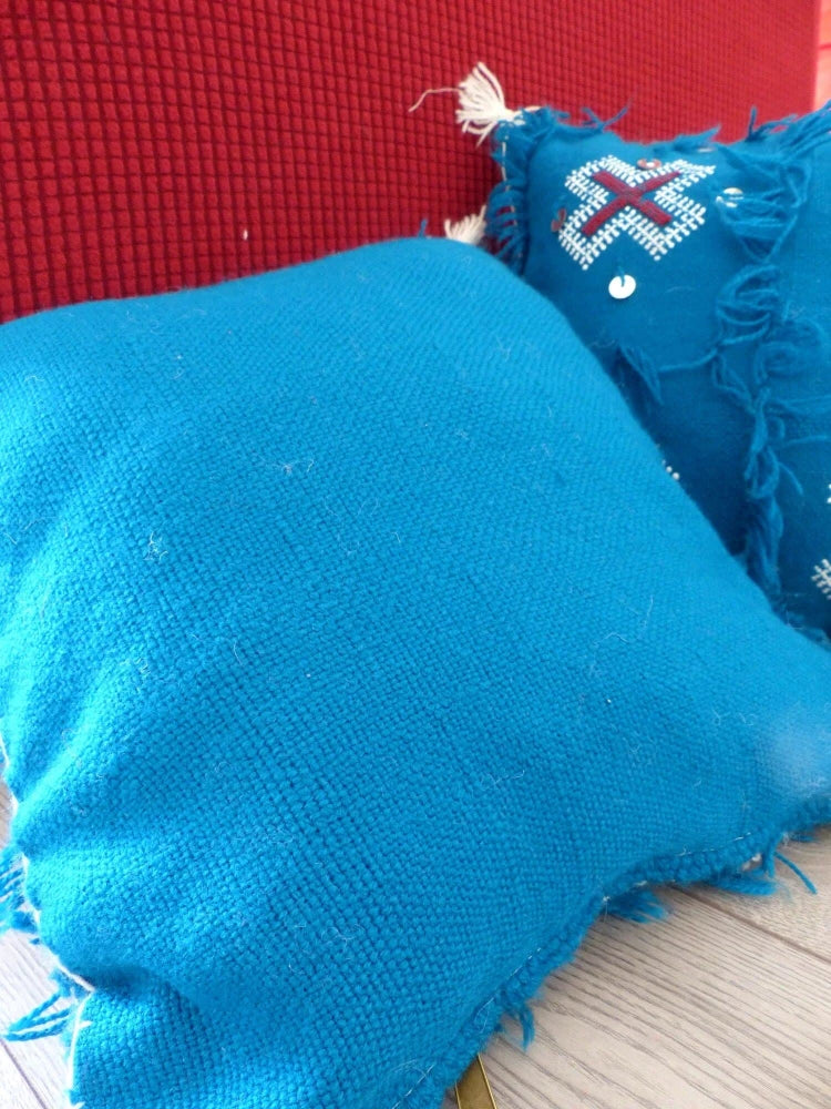 coussin bleu en coton