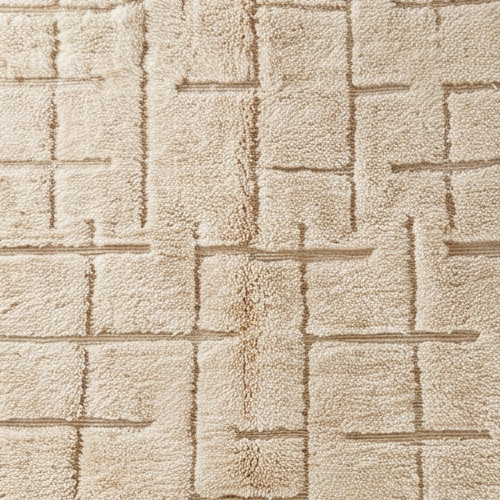 Gros plan de la laine et du motif quadrillage irrégulier en relief du tapis Béni Ouarain