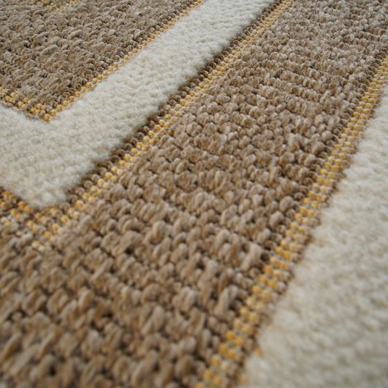 Tapis en jute aux motifs géométriques beige et marron clair, avec des bandes crème épaisses et fines lignes jaunes, à la texture bouclée.