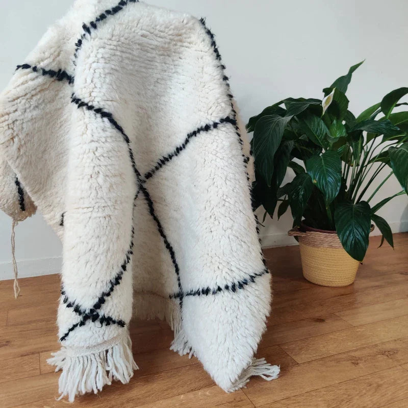 Tapis Marocain à Losanges Noirs à Côté d'une Plante