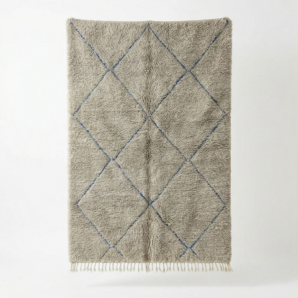 Grand tapis berbère gris à losanges bleus de style marocain avec texture douce et franges décoratives.
