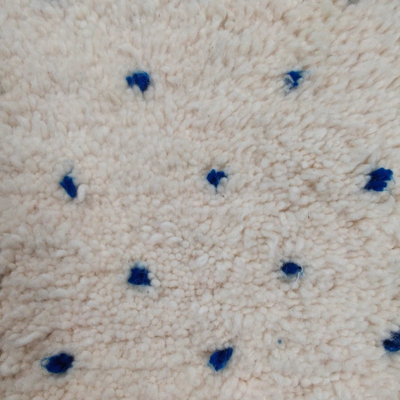 Zoom sur les détails des pois bleus du tapis berbère