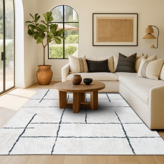 Tapis berbère géométrique en coton blanc à motifs de lignes noires irrégulières.