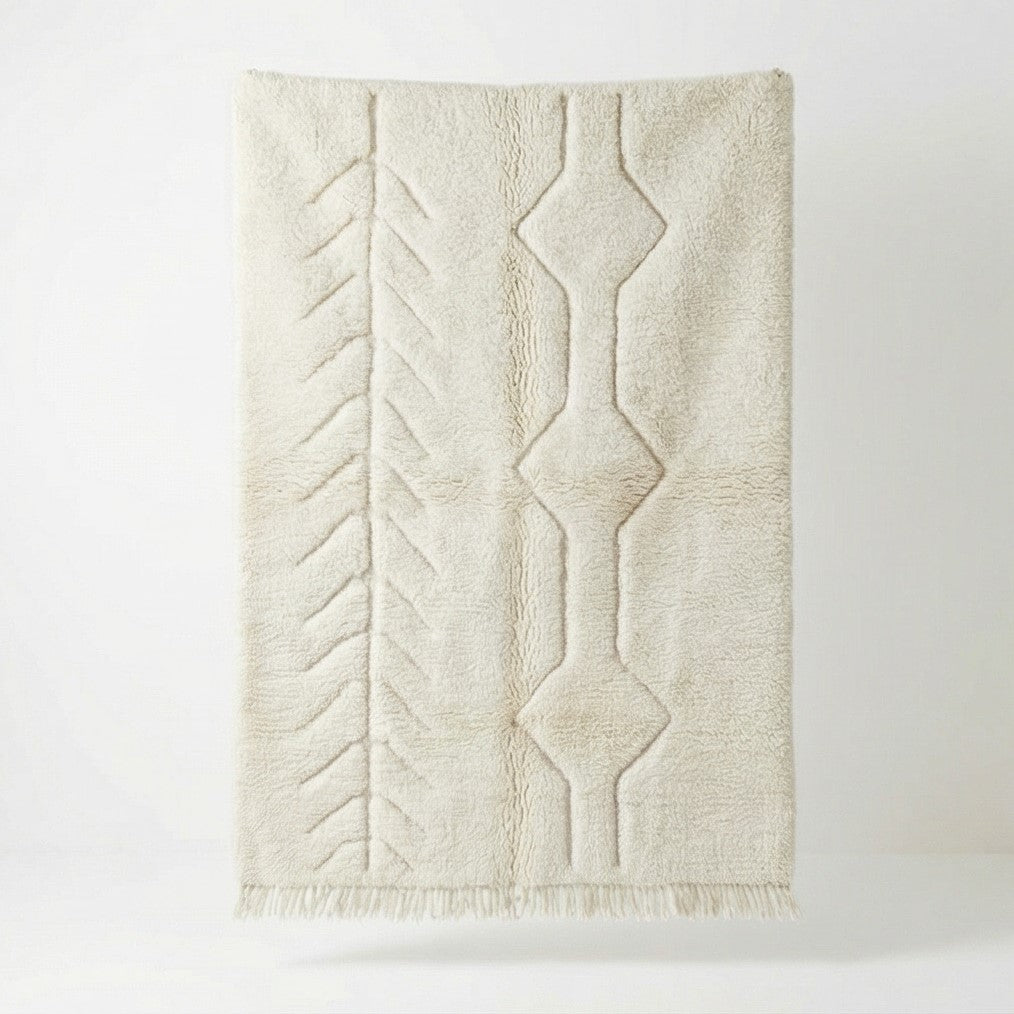 Tapis en peluche beige avec motifs géométriques, parfait pour la décoration intérieure.